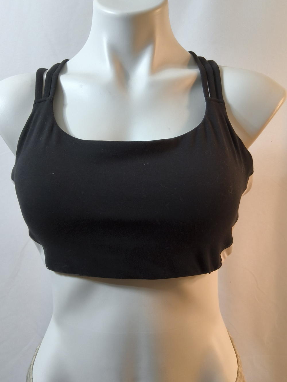 Athleta Sports Bras features  strappy criss-cross back design. Size L